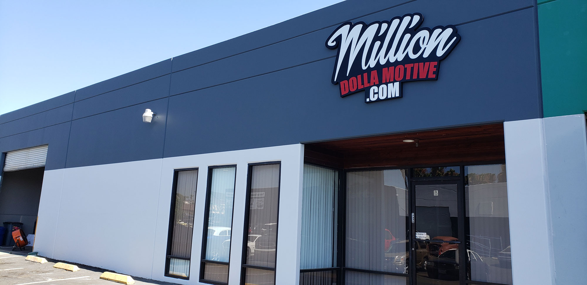 building-signs Building exterior with a "Million Dolla Motive .com" sign above the entrance.
